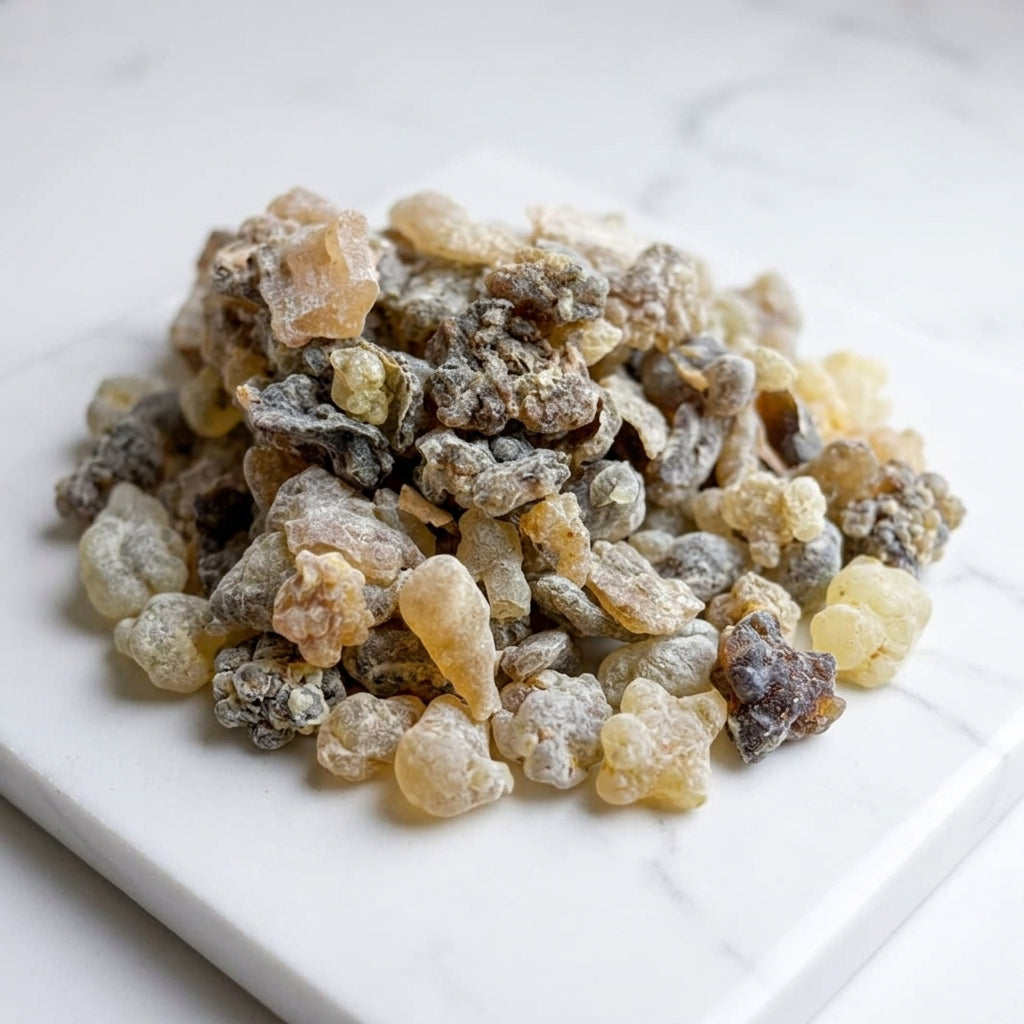 Heap of Black Hojari frankincense resin on a white surface